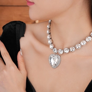 Detail of luxury heart pendant necklace with rhinestones on a female model