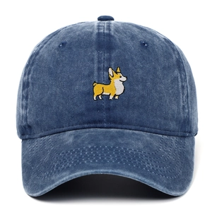 Close-up of cute Corgi dog embroidery on washed blue cotton baseball cap surface
