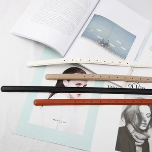 Minimalist skinny leather belts for women in four versatile colors on a stylish magazine