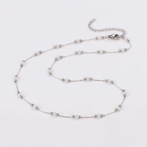 Detail of silver beaded necklace with white pearls, lobster clasp and extension chain