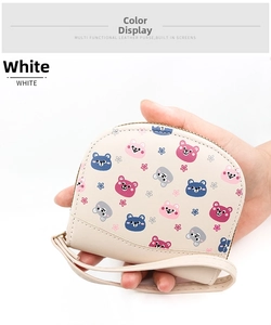 Close-up of white semi-circle coin purse with cartoon bear print and wrist strap