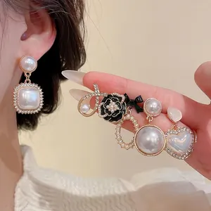 Elegant pearl earring set with rhinestone accents and vintage floral designs