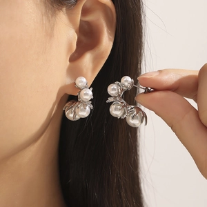 Chic 18K gold plated C-shaped pearl earrings with floral branch design on model