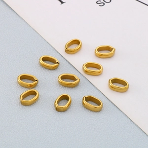 Macro shot of gold plated stainless steel pinch bails for DIY jewelry necklace making