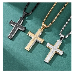 Detailed view of hip hop cross pendants in black, gold and silver with tire texture