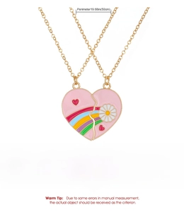 Detail view of heart-shaped necklace featuring a colorful rainbow and daisy enamel pattern