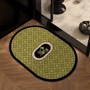 Oval absorbent bath mat with vintage green and brown patterns on wooden floor