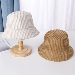 Detail showing high-quality corduroy bucket hats in beige and light brown colors