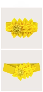 Detailed view of elastic yellow waist belt with large 3D sunflower fabric blossom