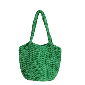 Vibrant green hand-woven cotton rope tote bag with textured hollow pattern for beach vacation