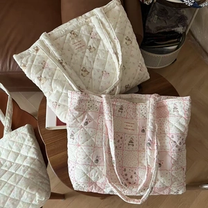 Detailed close-up of quilted cotton tote bags featuring cute bear and rabbit floral prints