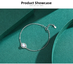 Macro detail of S925 sterling silver moonstone bracelet with pavé diamonds on green background