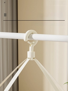 Detail of 360-degree rotating windproof hook on a cream white foldable laundry drying basket
