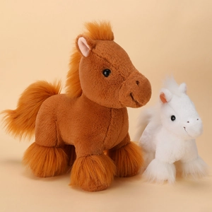 Realistic brown and white plush pony toys with soft fur and mane on beige background
