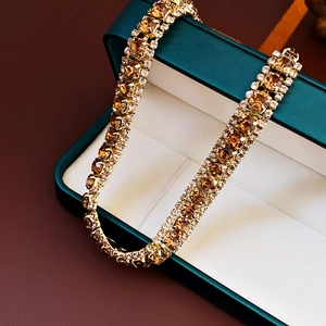 Macro shot of French luxury square amber stone necklace with crystals in a green box