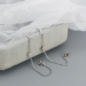 Close-up of S925 sterling silver star and moon tassel earrings with shiny zircon inlay