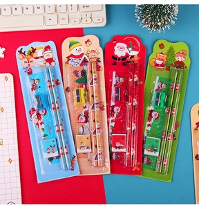 Close-up of four colorful Christmas stationery sets with pencils, ruler, eraser and sharpener