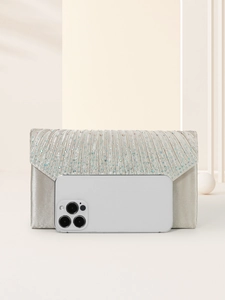 Champagne evening clutch bag with rhinestones next to a smartphone for size reference