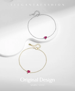Close-up of S925 sterling silver heart bracelets with red gems in gold and silver finish