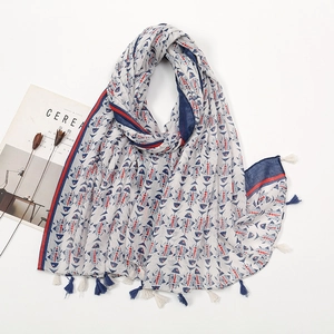 Close-up of bohemian scarf with red and blue fish patterns and elegant fringe trim