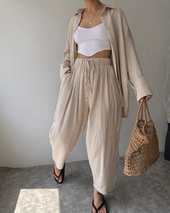 Detail of apricot linen three-piece set featuring long sleeve shirt and wide leg pants