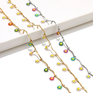 Detailed macro view of colorful daisy pendants on gold and silver stainless steel chains