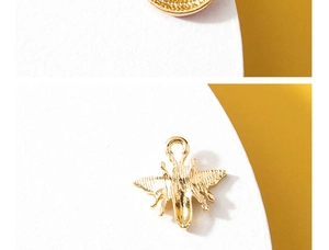 Detailed view of a golden bee-shaped alloy pendant with sparkling rhinestone accents