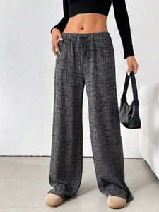Detail of grey high-waisted wide-leg trousers with drawstring waist and textured fabric