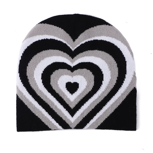 Winter knitted beanie featuring stylish concentric heart patterns in black, grey, and white