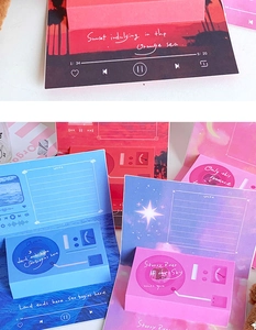Close-up of retro music player pop-up cards with sunset and starry sky themes