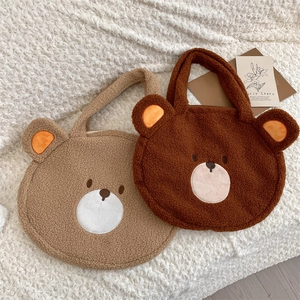 Detail of plush bear tote bags in light and dark brown showing fuzzy fleece texture