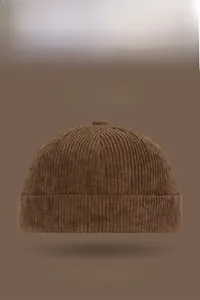 Macro shot of brown corduroy texture and rolled edge on a vintage docker cap
