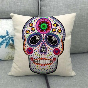 Bohemian colorful sugar skull linen pillow cover on a modern gray fabric sofa