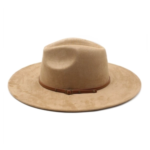 Detail of khaki suede fedora hat featuring a brown leather band and metal buckle