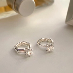 Macro shot of S925 sterling silver hoop earrings with round cut clear cubic zirconia drops