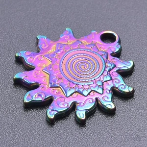 Macro shot of mandala sun pendant with iridescent rainbow plating and spiral pattern