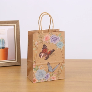 Kraft paper gift bag with butterfly and flower prints and twisted rope handles