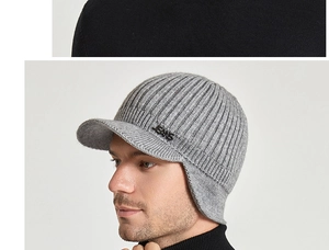 Close-up of a light grey winter knit hat with a brim and metallic JEANS detail