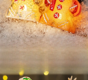 Close-up of a glowing gingerbread man night light with warm LED and festive sparkles