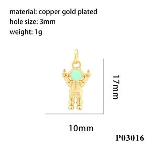 Macro view of 18K gold plated astronaut pendant with dimensions 17mm x 10mm and green enamel