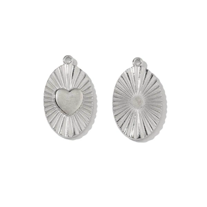 Macro shot of oval sunburst pattern steel charms with central heart and polished finish
