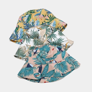 Foldable tropical print bucket hats for women in yellow, white and pink colors