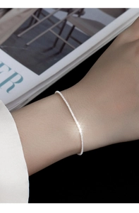 Close-up of sparkling S925 sterling silver star chain bracelet worn on a female wrist