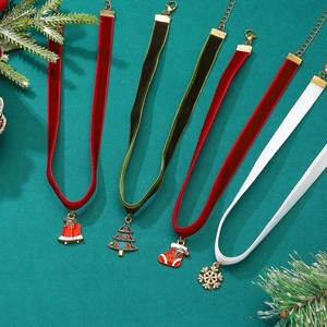 Christmas velvet choker necklace set with bells and tree charms on a festive background