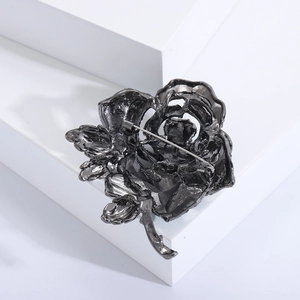 Detailed back view of flower brooch showing gunmetal pin fastening and sturdy metal structure