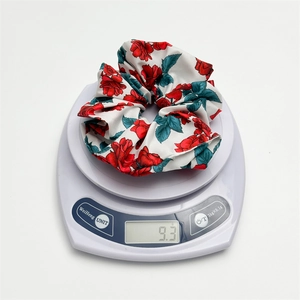 Detailed view of lightweight 9.3g white scrunchie with red rose floral print pattern