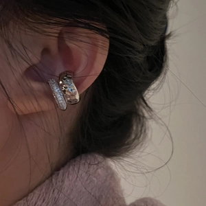 Detail of silver double layer ear cuff with hammered texture and cubic zirconia on model
