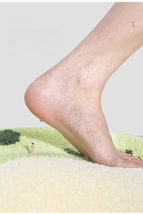 Close-up of thick pile cartoon bath mat with green and cream high-density plush texture