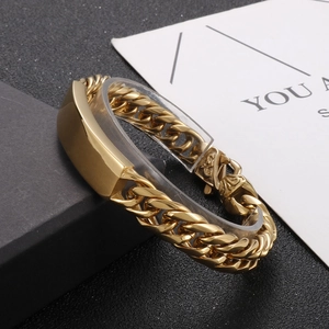 Polished gold cuban link bracelet for men with curved metal plate on black luxury background