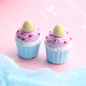 Close-up of two resin cupcakes with purple frosting and blue bases for DIY crafts